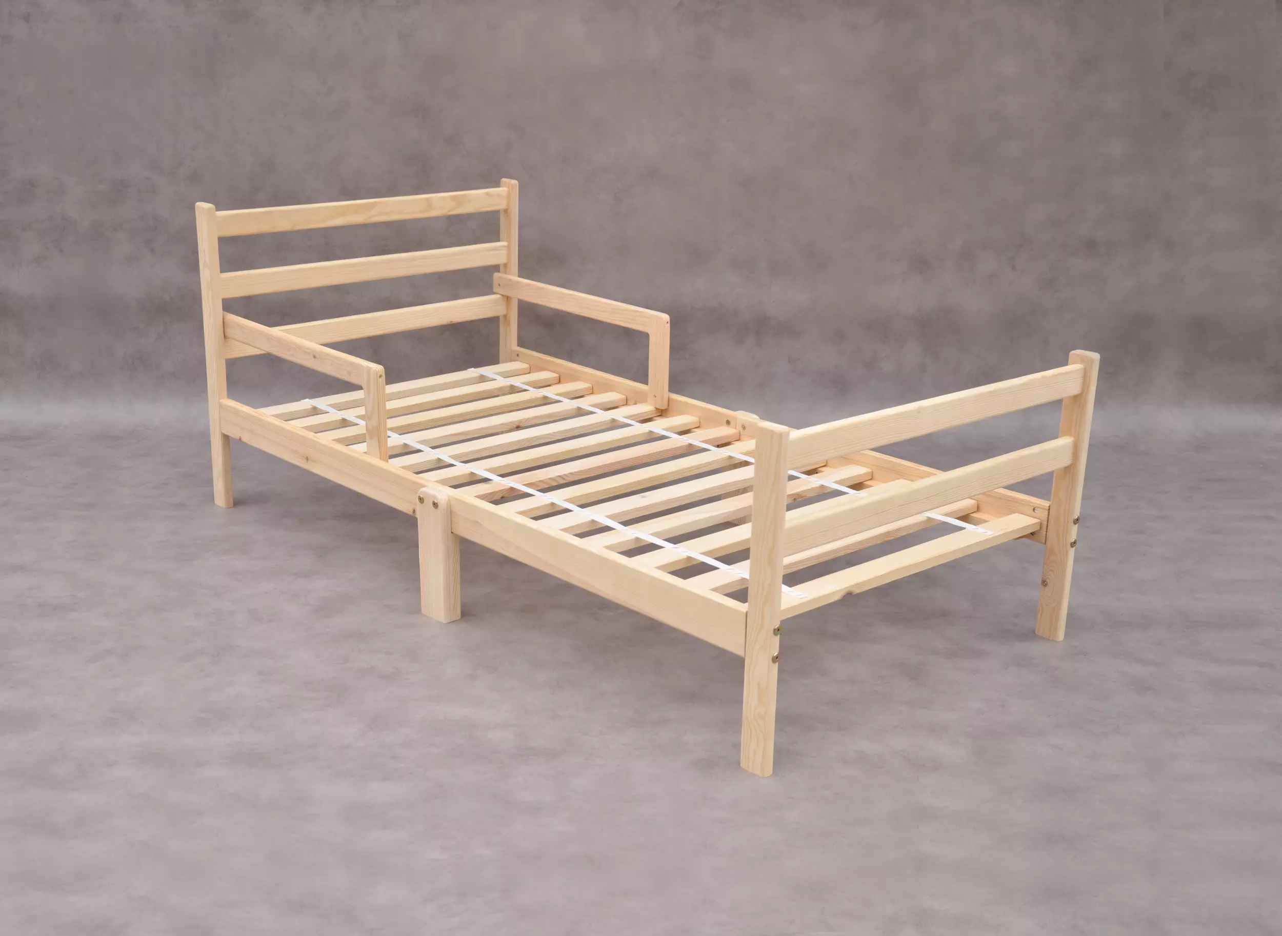 Toddler bed Baltic Pine Forest small child's single bed, low height Montessori bed frame with safety rails on both sides for sale at Barin Toys online shop with free delivery.